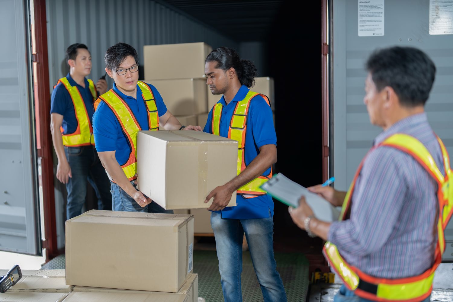 men offloading trucks with boxes